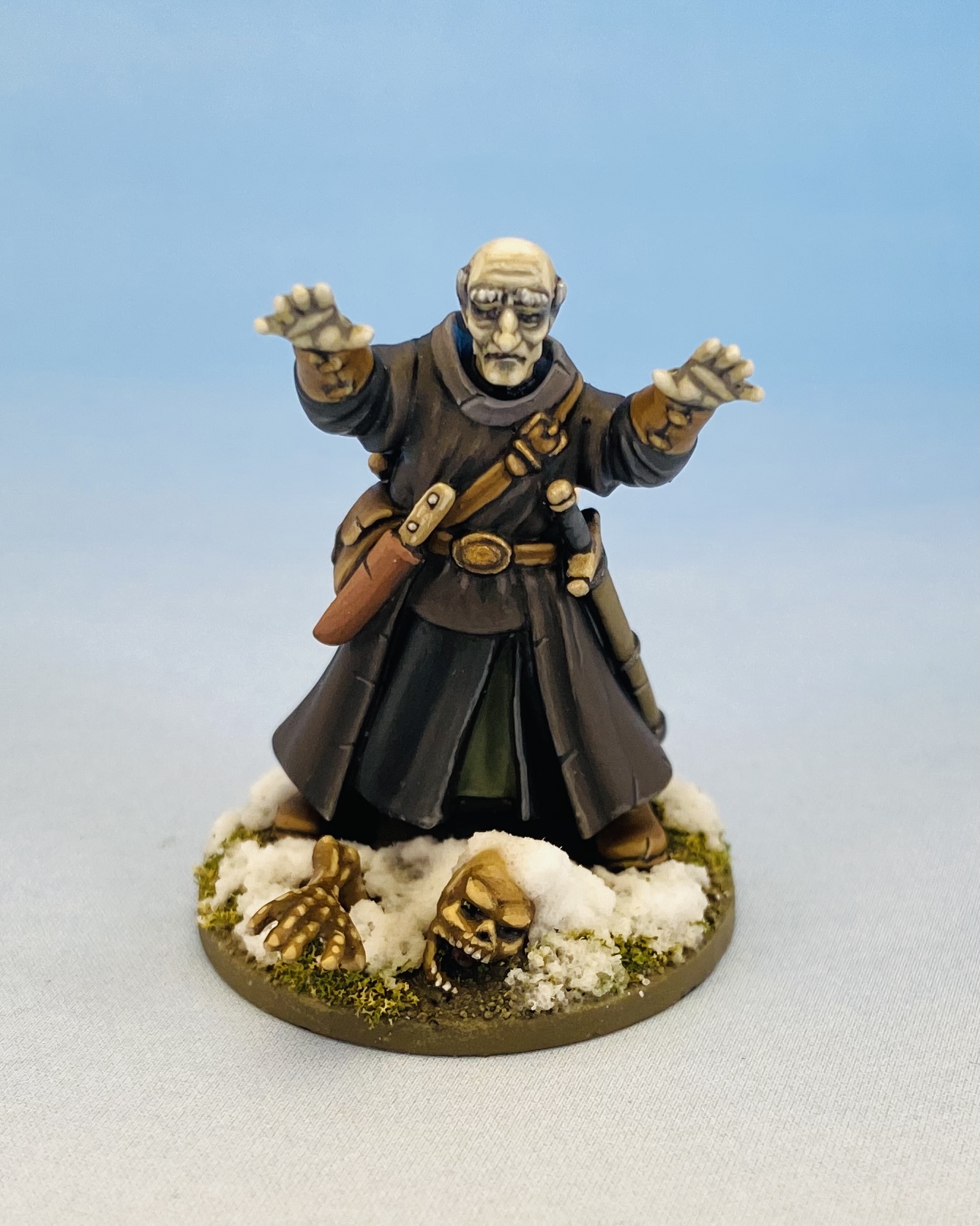 Frostgrave necromancer miniature summoning a skeleton from the ground